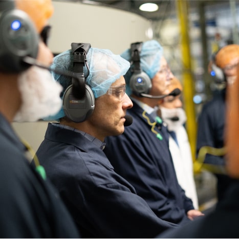 team members with disposable head nets and mics