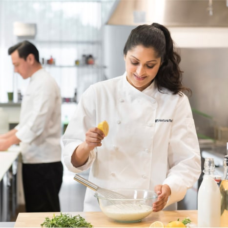 Smiley chef preparing sauces