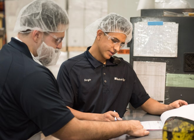 Corporate Citizenship Image - Food Processing Technicians Checking Reports