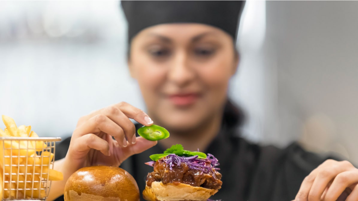 Female chef preparing food to serve