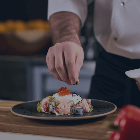 chef seasoning the food to serve