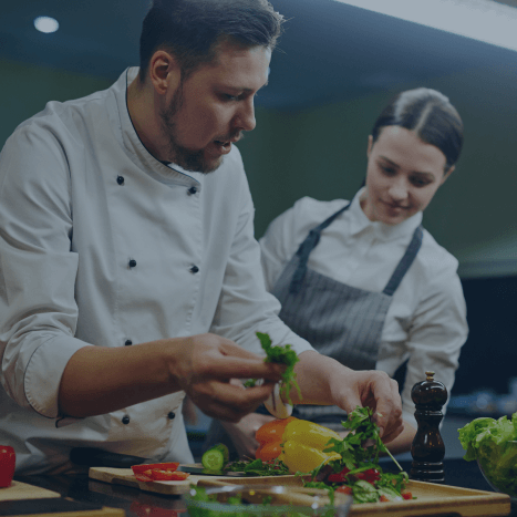 chefs preparing food in the kitchen