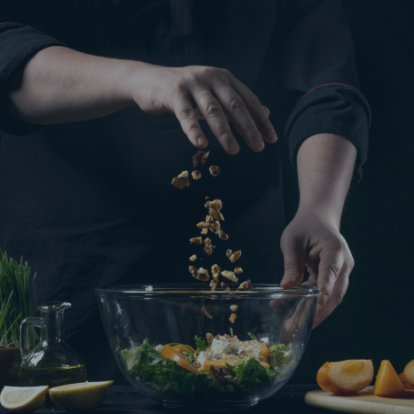 Hands preparing salads